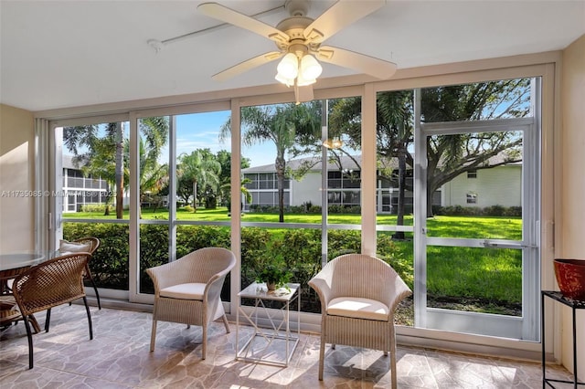 sunroom featuring ceiling fan