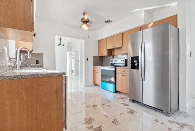 16025 NW 29th Ave, Miami Gardens, FL 33054 - kitchen with decorative backsplash, marble finish floor, a sink, and appliances with stainless steel finishes