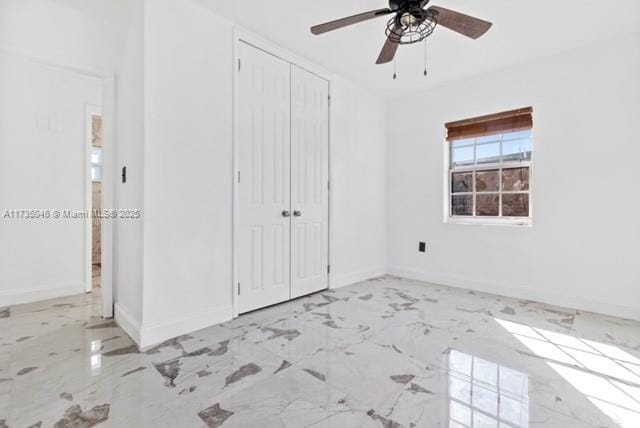 16025 NW 29th Ave, Miami Gardens, FL 33054 - unfurnished bedroom featuring ceiling fan, baseboards, marble finish floor, and a closet