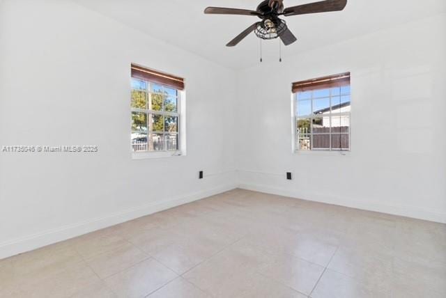 spare room with a wealth of natural light and ceiling fan