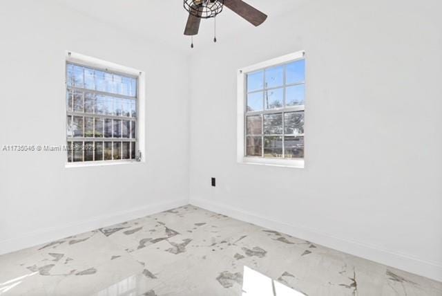 16025 NW 29th Ave, Miami Gardens, FL 33054 - spare room featuring baseboards, marble finish floor, and ceiling fan