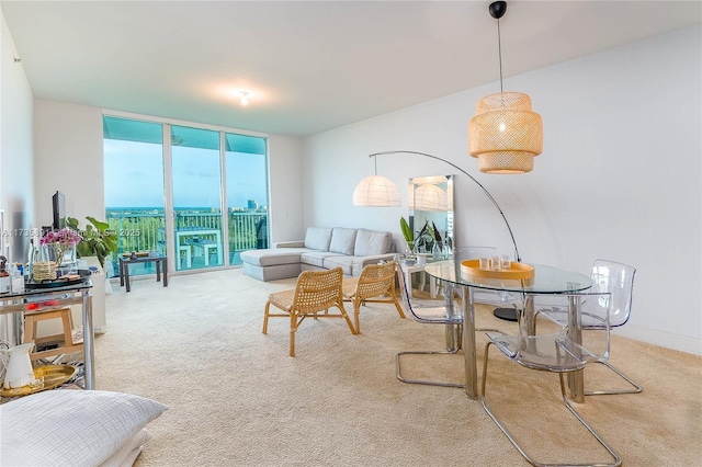 carpeted living room featuring floor to ceiling windows