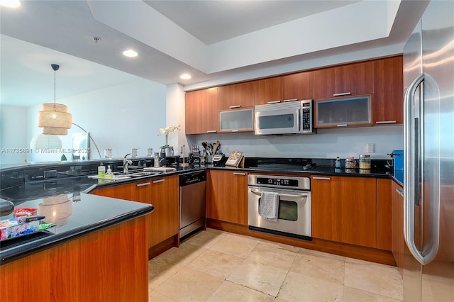 kitchen featuring sink, decorative light fixtures, and appliances with stainless steel finishes