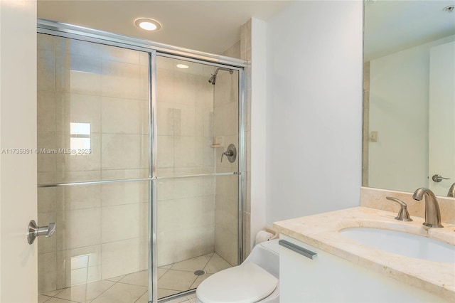 bathroom featuring vanity, an enclosed shower, and toilet