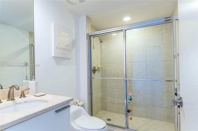 bathroom with vanity, an enclosed shower, and toilet