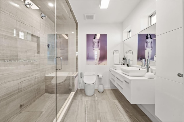 bathroom featuring vanity, an enclosed shower, and toilet