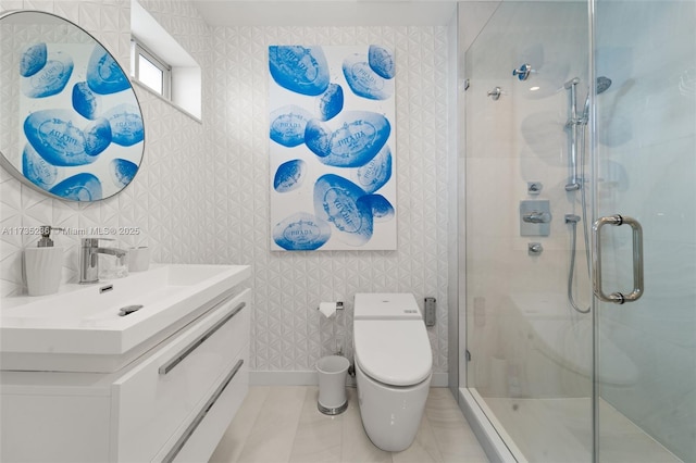 bathroom with tile patterned flooring, vanity, an enclosed shower, and toilet