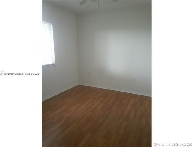 spare room with dark hardwood / wood-style flooring