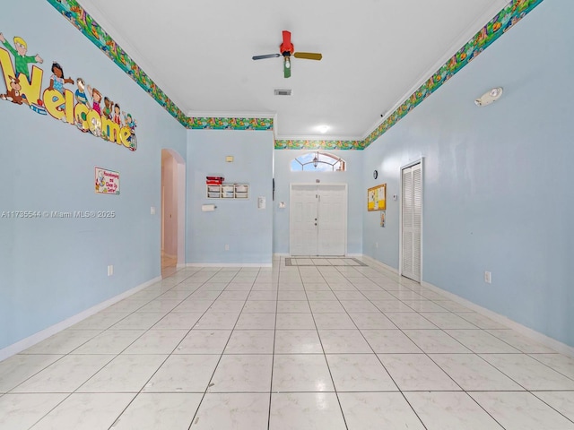 15804 SW 99th Ter, Miami, FL 33196 - unfurnished room with ceiling fan, arched walkways, crown molding, light tile patterned floors, and baseboards