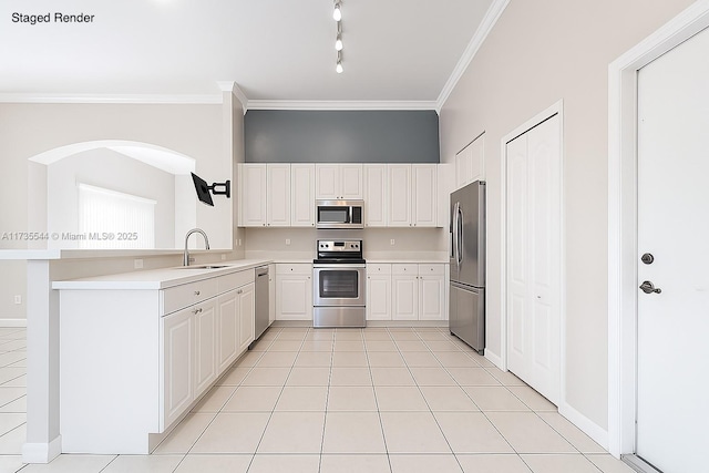 15804 SW 99th Ter, Miami, FL 33196 - kitchen featuring appliances with stainless steel finishes, crown molding, light countertops, a peninsula, and white cabinetry