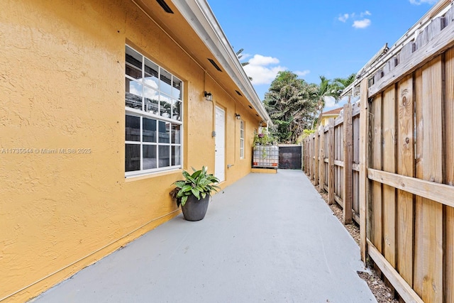 15804 SW 99th Ter, Miami, FL 33196 - view of property exterior featuring stucco siding and a patio