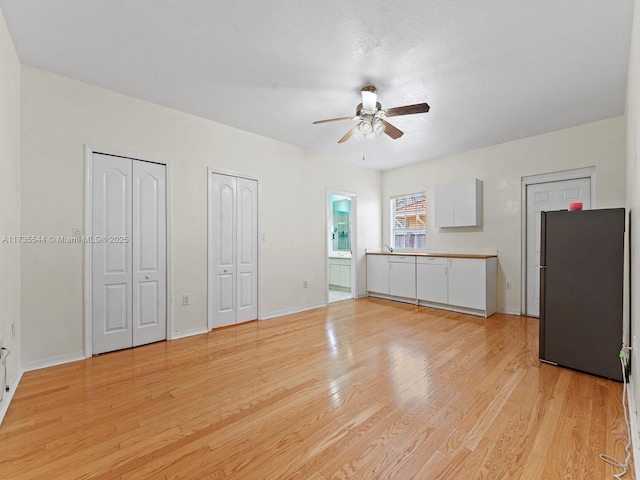 15804 SW 99th Ter, Miami, FL 33196 - unfurnished living room with a ceiling fan, light wood-style floors, and baseboards