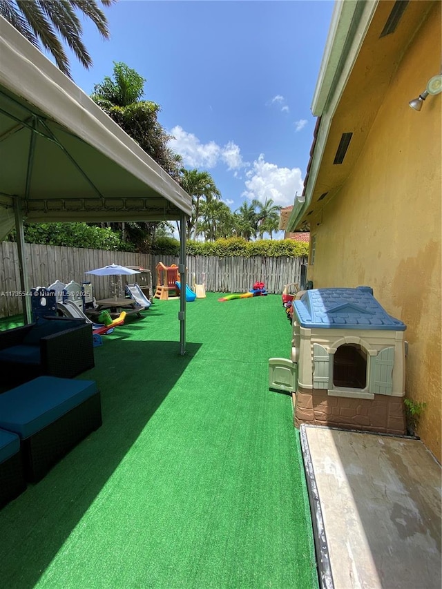 15804 SW 99th Ter, Miami, FL 33196 - fenced backyard with a gazebo, a playground, and a patio area