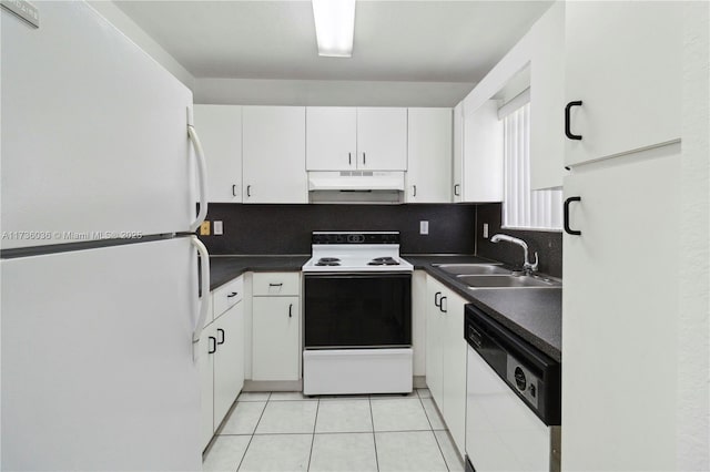 7011 W 29th Ave Unit 210, Hialeah, FL 33018 - kitchen with white appliances, under cabinet range hood, white cabinets, dark countertops, and light tile patterned floors