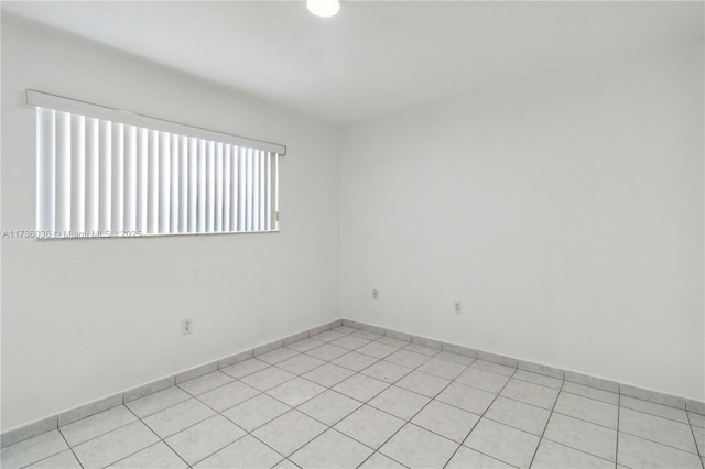 7011 W 29th Ave Unit 210, Hialeah, FL 33018 - unfurnished room with light tile patterned floors and baseboards