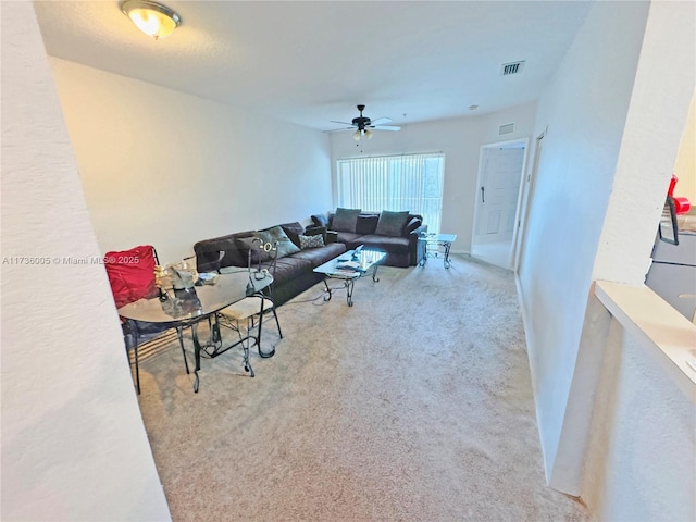 living room featuring ceiling fan and light colored carpet