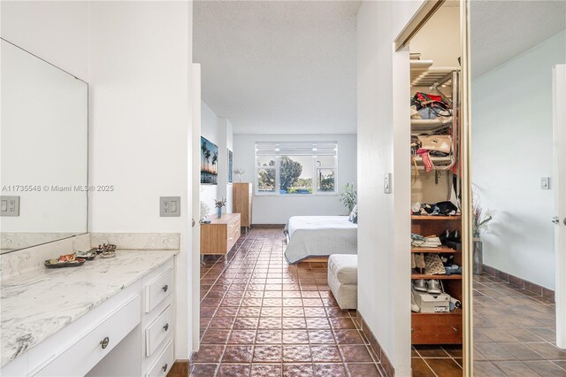 bathroom featuring tile patterned floors, vanity, and a textured ceiling