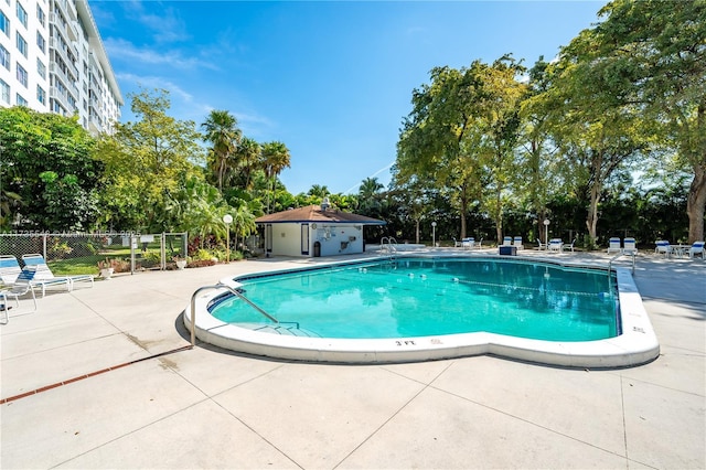 view of swimming pool with a patio