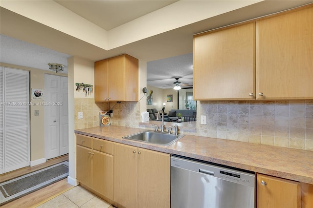 kitchen with light brown cabinetry, sink, stainless steel dishwasher, ceiling fan, and decorative backsplash