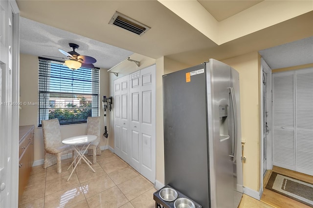 bathroom featuring ceiling fan, tile patterned flooring, and a textured ceiling