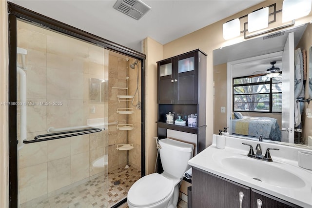 bathroom with walk in shower, ceiling fan, vanity, and toilet