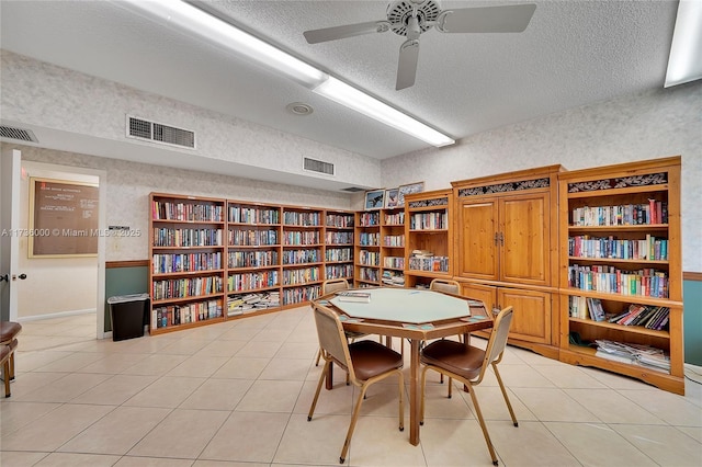 dining area featuring ceiling fan, a textured ceiling, and light tile patterned flooring