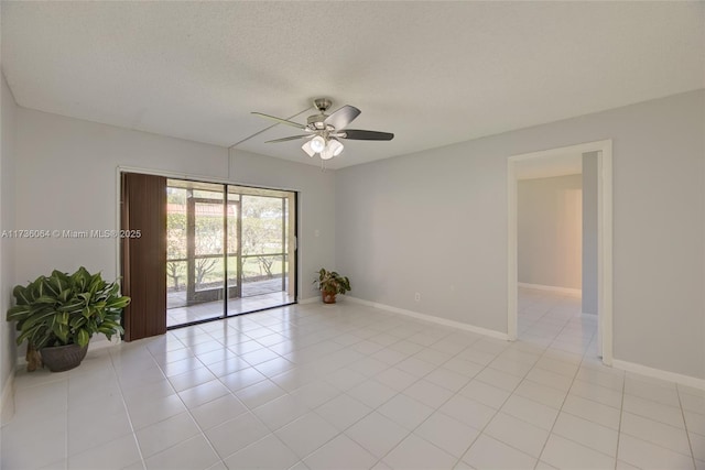 tiled spare room featuring ceiling fan and a textured ceiling