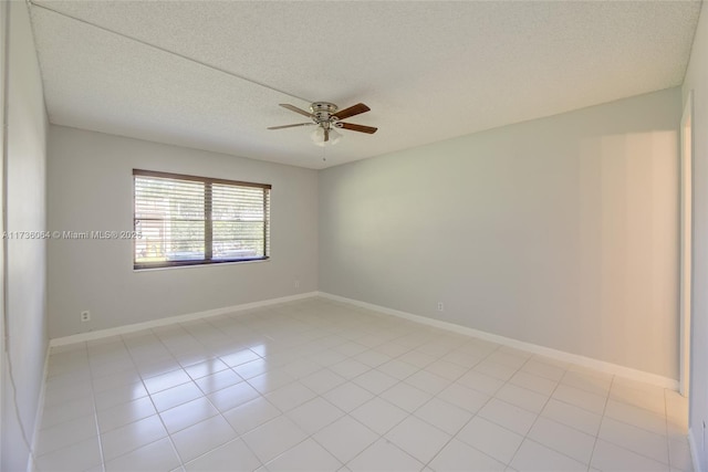 spare room with light tile patterned floors, a textured ceiling, and ceiling fan