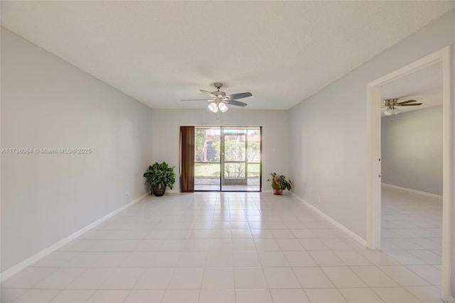 tiled empty room featuring a textured ceiling and ceiling fan