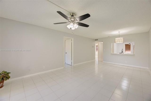 tiled spare room featuring sink, a textured ceiling, and ceiling fan