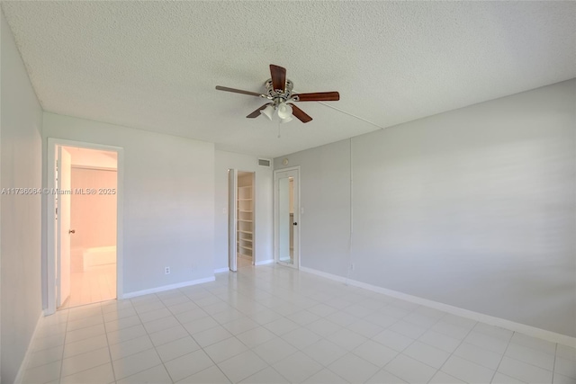 unfurnished room featuring ceiling fan and a textured ceiling