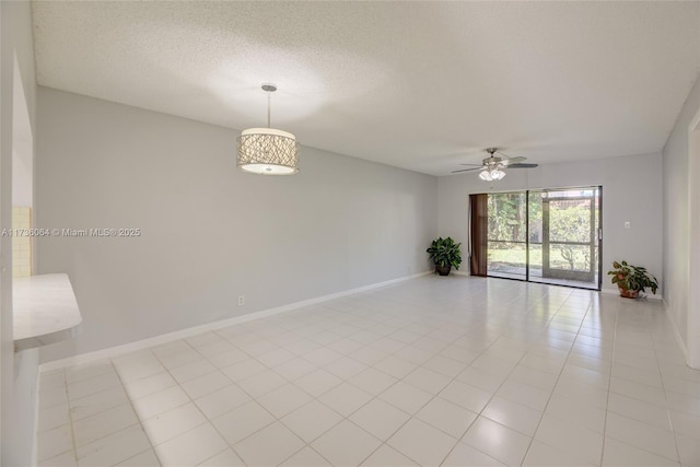 unfurnished room with ceiling fan, light tile patterned floors, and a textured ceiling