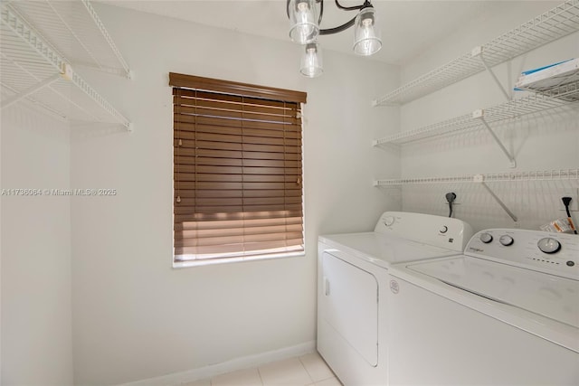 washroom featuring washer and clothes dryer and light tile patterned floors