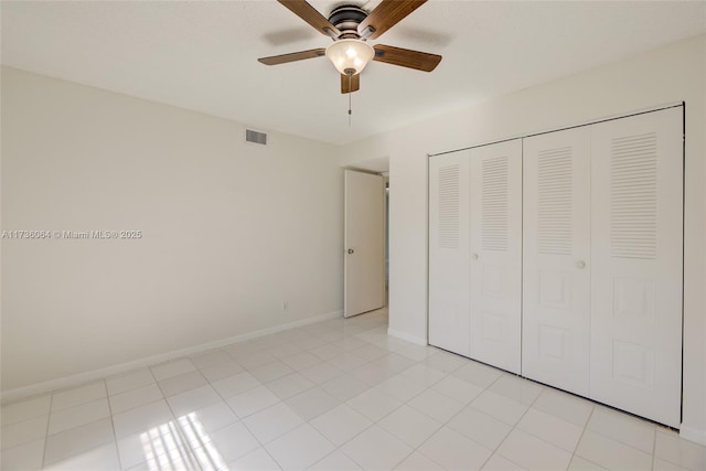 unfurnished bedroom featuring light tile patterned flooring, ceiling fan, and a closet