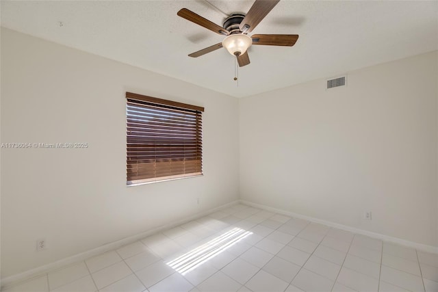 unfurnished room with light tile patterned floors and ceiling fan