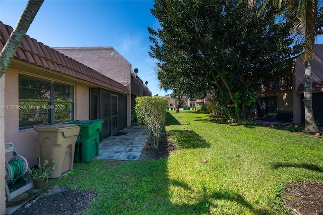 view of yard with a sunroom