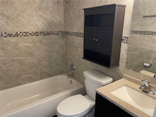 full bathroom featuring vanity, tiled shower / bath combo, tile walls, and toilet