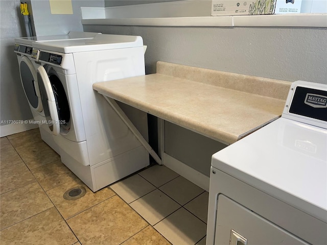 washroom with light tile patterned floors and independent washer and dryer