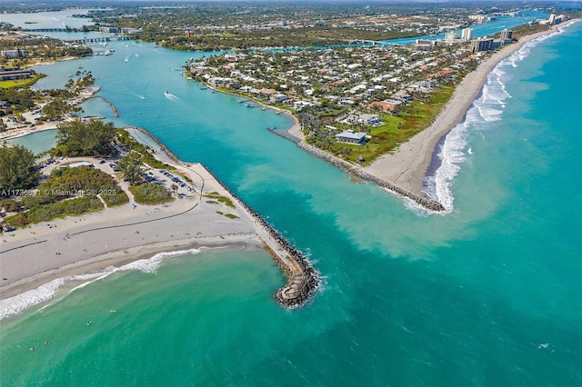 birds eye view of property featuring a water view and a beach view