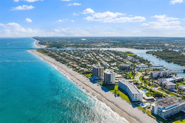 birds eye view of property with a beach view, a water view, and a city view