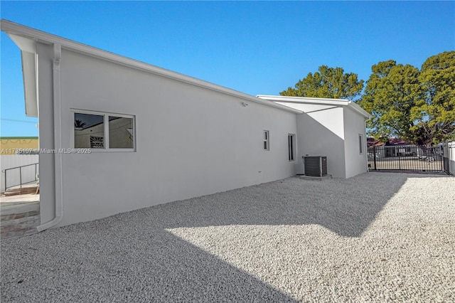 back of house featuring cooling unit