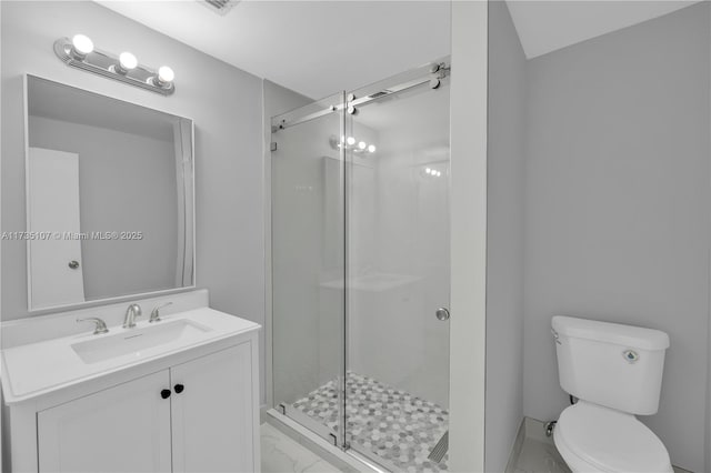 bathroom with vanity, toilet, and a shower with shower door