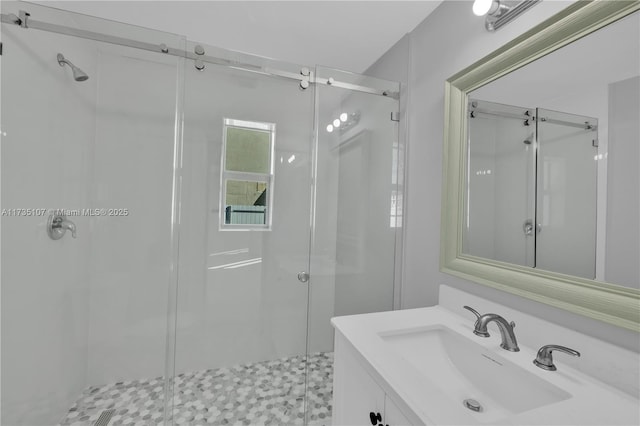 bathroom with a shower with door and vanity