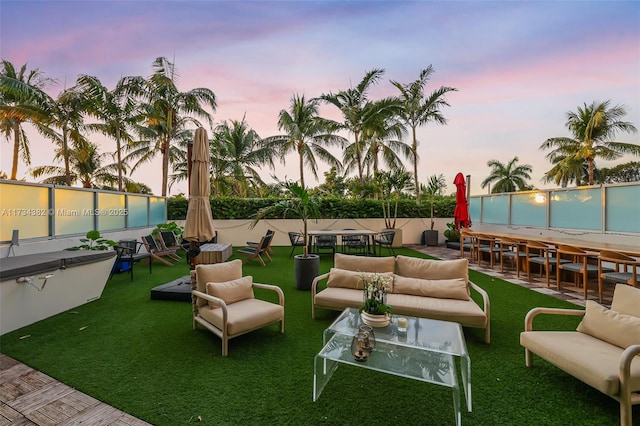 view of community featuring outdoor lounge area and a lawn