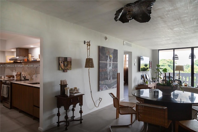 dining space with a wall of windows