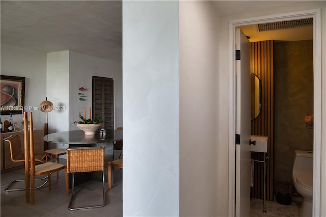 hallway with tile patterned flooring