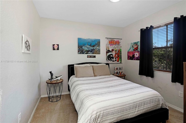 bedroom featuring light carpet and baseboards