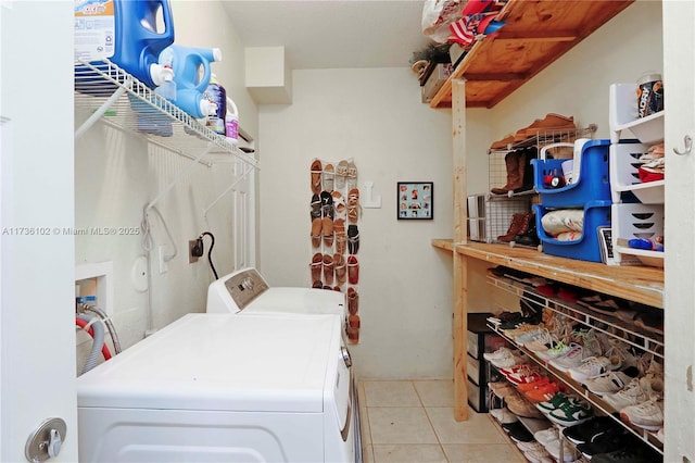 washroom with laundry area, washer and clothes dryer, and light tile patterned floors