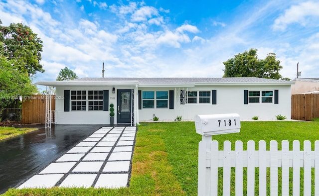 ranch-style home with a front lawn