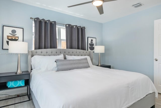 bedroom with ceiling fan and light wood-type flooring